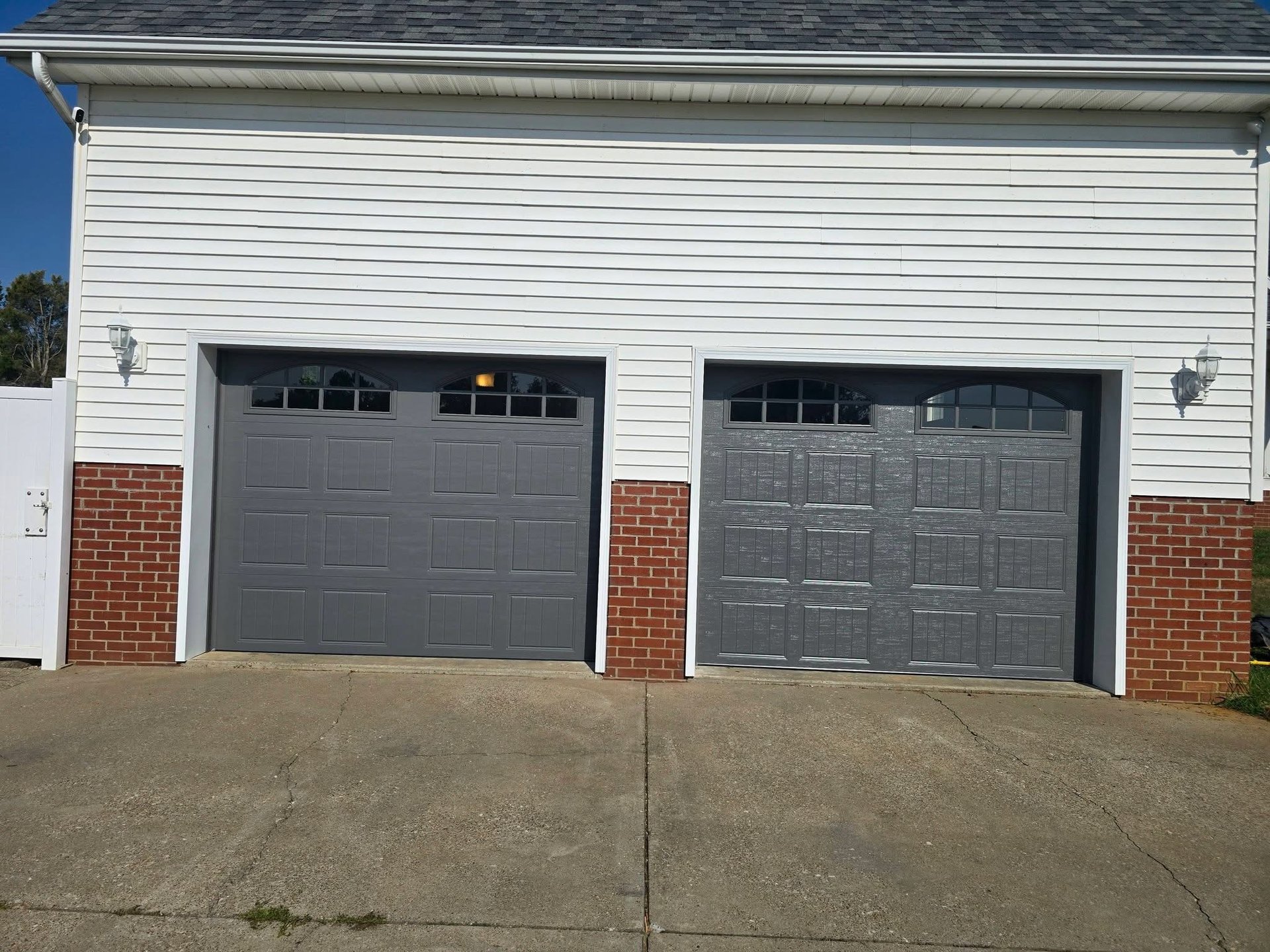 Completed matching garage door installation on a brick home in Henderson, KY